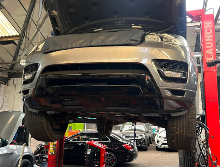 Vehicle undergoing engine repair in a professional workshop