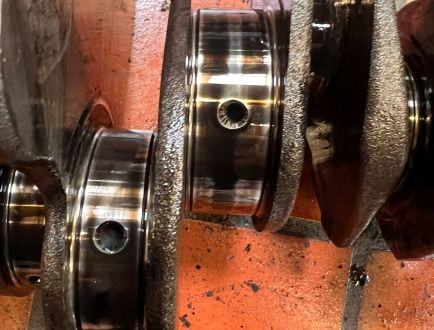 Close-up of crankshaft bearing journal during engine rebuild inspection