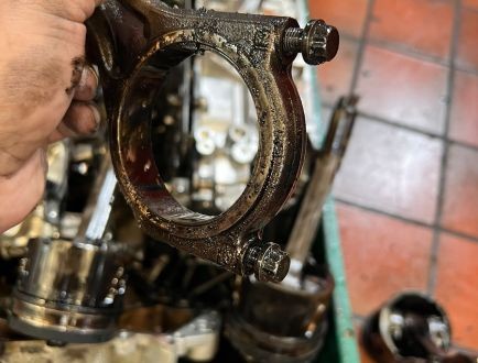 Removed engine component being inspected during engine rebuild
