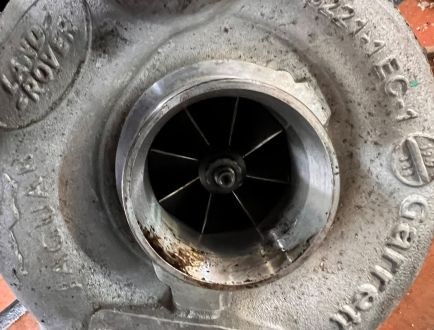 Close-up of turbocharger housing and internal components during inspection