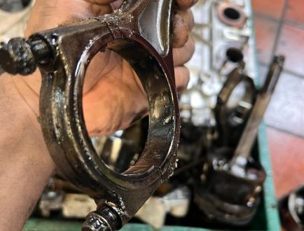 Engine component being inspected during professional engine reconditioning